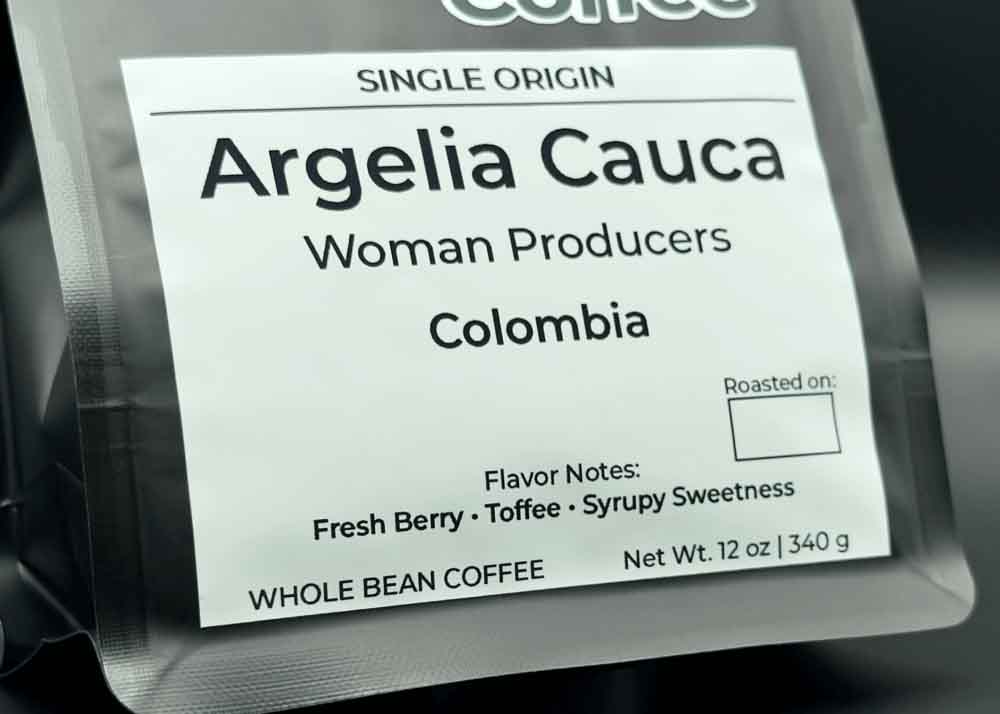 Label close-up of Argelia Cauca coffee bag, tasting notes: fresh berry, toffee, and syrupy sweetness