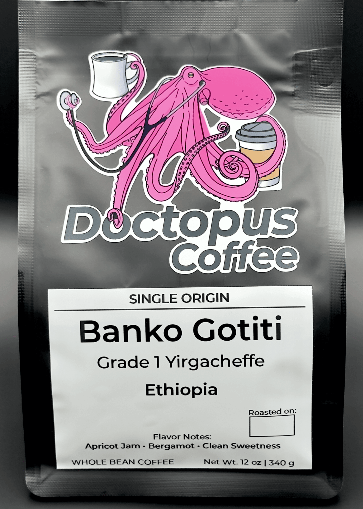 Doctopus Coffee black bag featuring pink octopus logo holding coffee cups. Label shows Grade 1 Banko Gotiti Yirgacheffe from Ethiopia, with flavor notes of apricot jam, bergamot, and clean sweetness