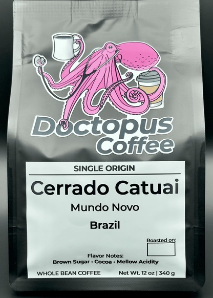 Doctopus Coffee black bag featuring pink octopus logo holding coffee cups. Label shows Single Origin Cerrado Catuai from Brazil with Mundo Novo variety