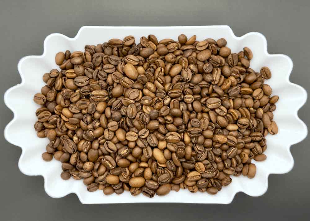 Freshly roasted Dembi Sidama Ethiopian coffee beans in a dish