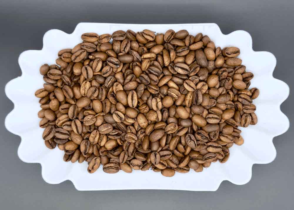Freshly roasted Finca Tacacal Costa Rican coffee beans in a dish