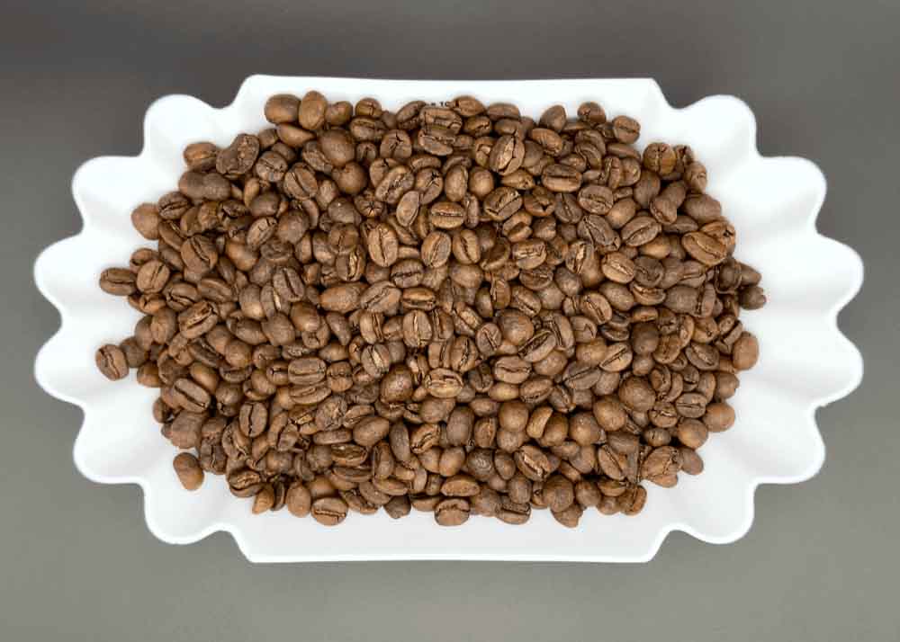 Freshly roasted Triunfo Verde Mexican organic decaf coffee beans in a dish